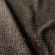 Gros plan sur un tissu texturé brun foncé dont la trame est visible et dont les plis et les ombres sont doux et irréguliers. Canape Paris by Atelier Bis